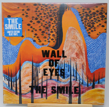 Vinyl record cover with abstract design and text 'The Smile' on a white background