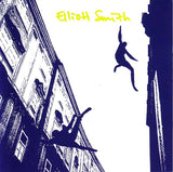 Album cover with silhouettes of people on buildings and the text 'Eliott Smith' in yellow.