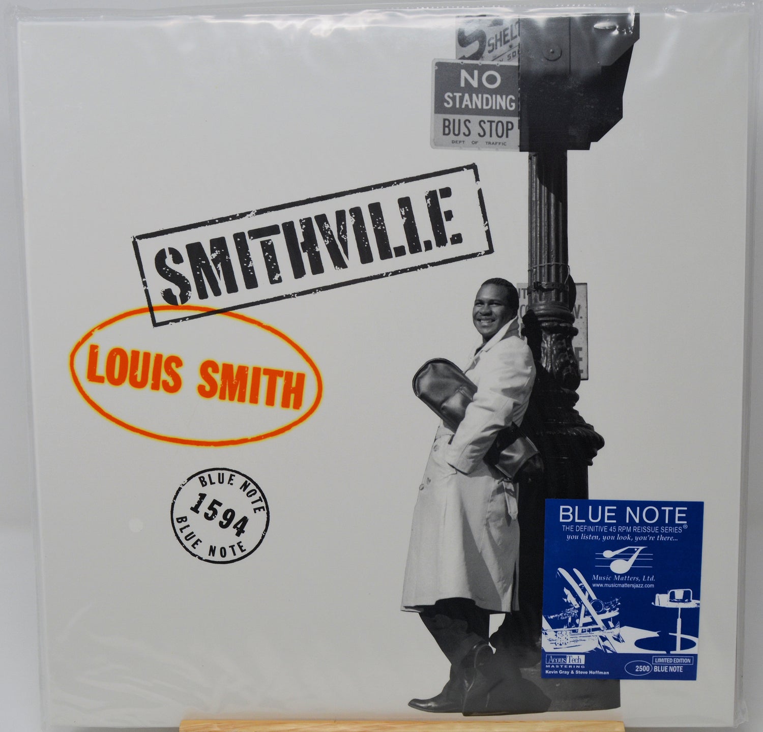 Louis Smith's 'Smithville' Blue Note vinyl record album, still sealed in its original plastic shrink wrap. The cover features a black and white photograph of a man leaning against a street lamp, with a blue 'Blue Note' sticker in the bottom right corner.