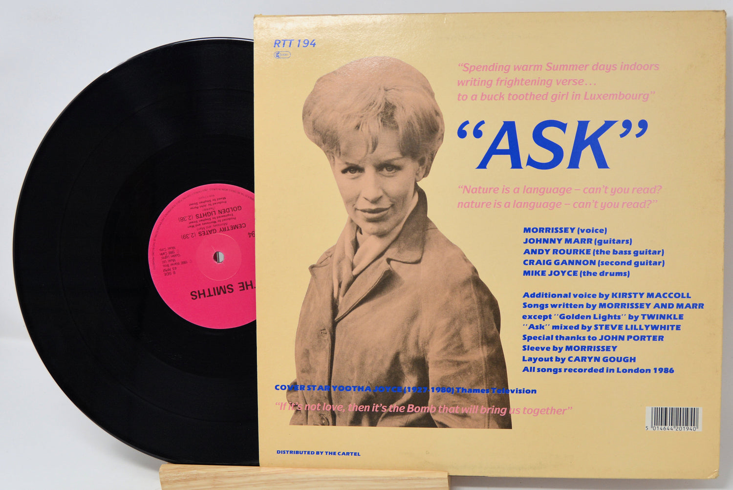 Vinyl record with cover featuring a young boy and text 'ASK' on a beige background.
