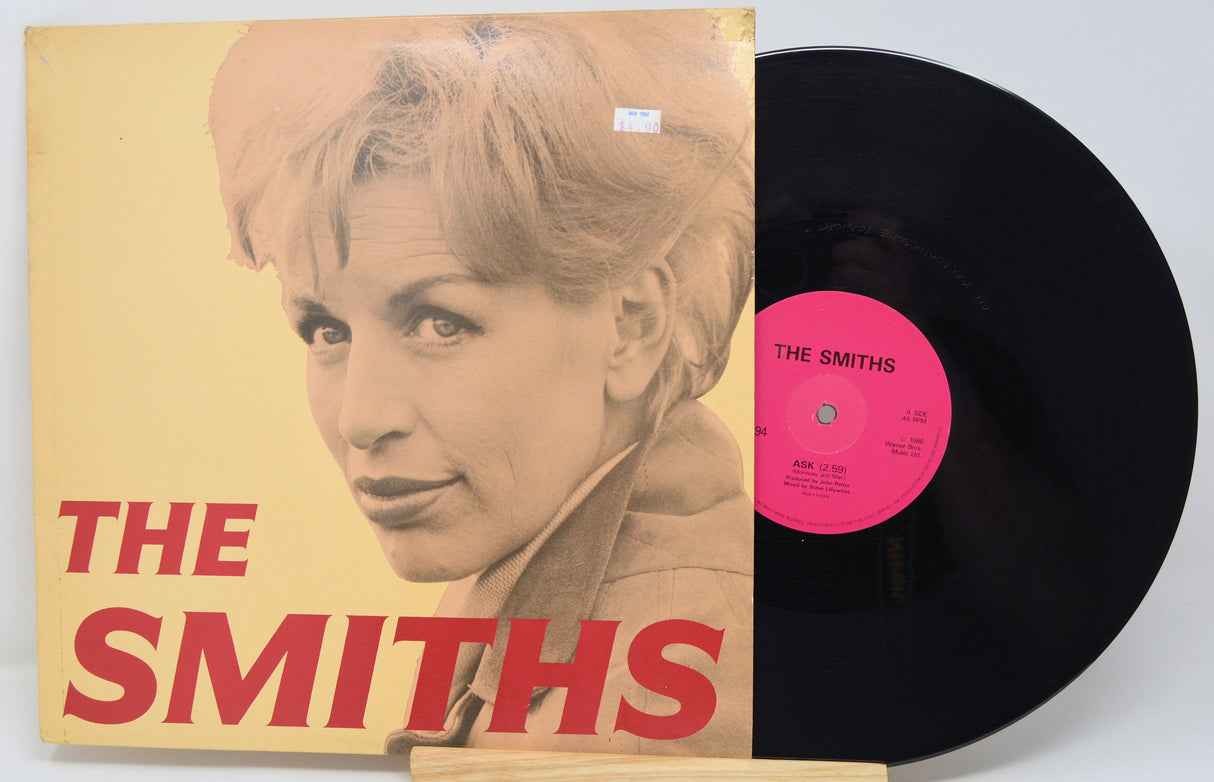 Vinyl record with 'The Smiths' album cover featuring a portrait of a woman.