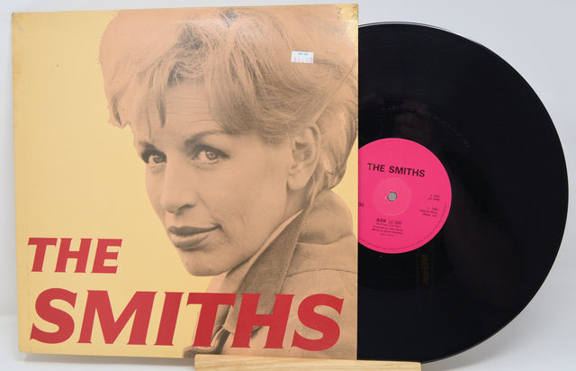 Vinyl record with 'The Smiths' album cover featuring a portrait of a woman.