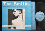 Album cover for The Smiths - Hatful of Hollow featuring a black and white photograph of a man's profile against a blue background.