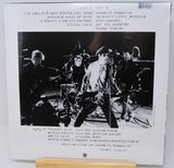 Vinyl record with a black and white photo of a band on the cover, featuring text and a barcode.