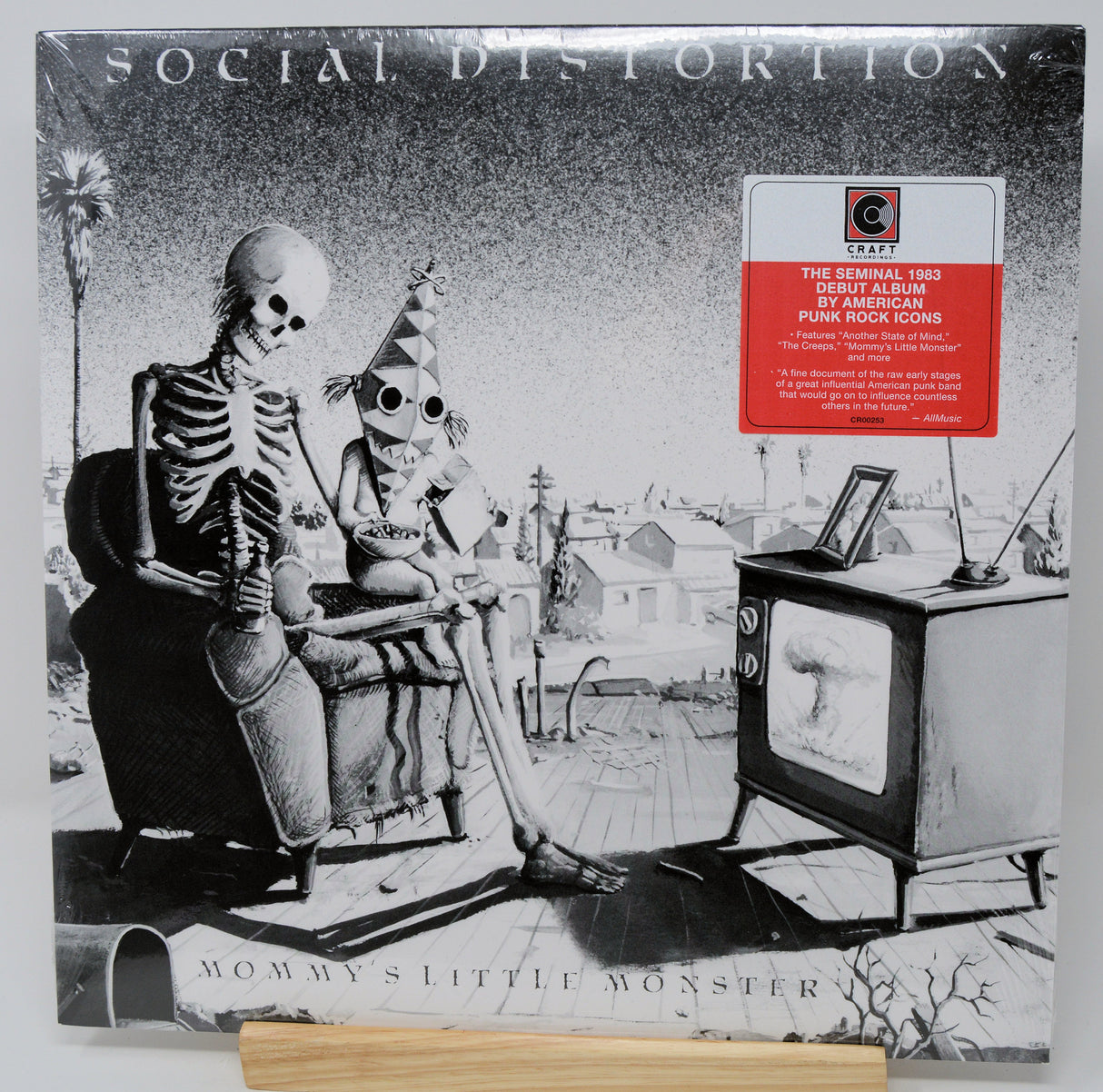 Vinyl record cover for Social Distortion's 'Mommy's Little Monster' with skeleton and child illustration.