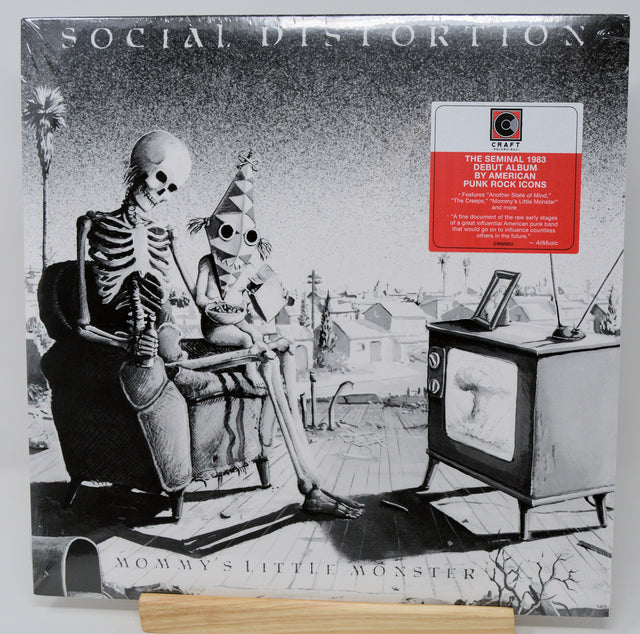 Vinyl record cover for Social Distortion's 'Mommy's Little Monster' with skeleton and child illustration.