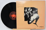 Vinyl record with cover featuring a group of people and a large fish illustration.