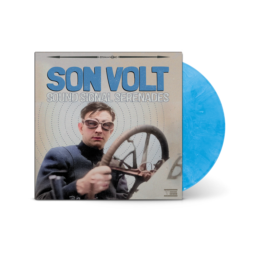Vinyl record with a blue disc and cover featuring a person with sunglasses and a steering wheel.