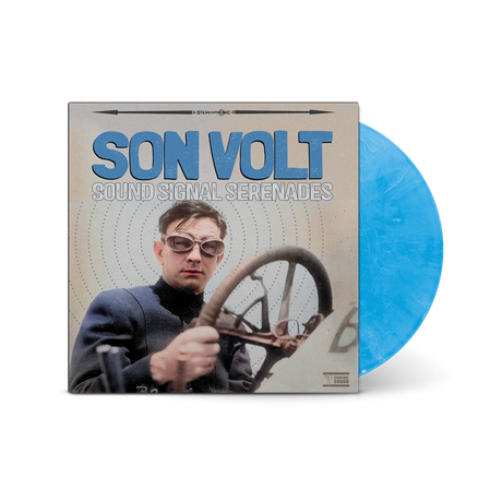 Vinyl record with a blue disc and cover featuring a person with sunglasses and a steering wheel.