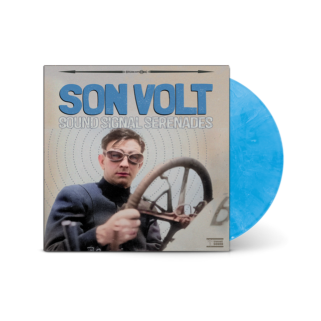 Vinyl record with a blue disc and cover featuring a person with sunglasses and a steering wheel.