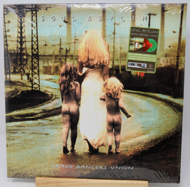 Vinyl record cover with a stylized image of three figures and text 'Soul Asylum' on a white background.