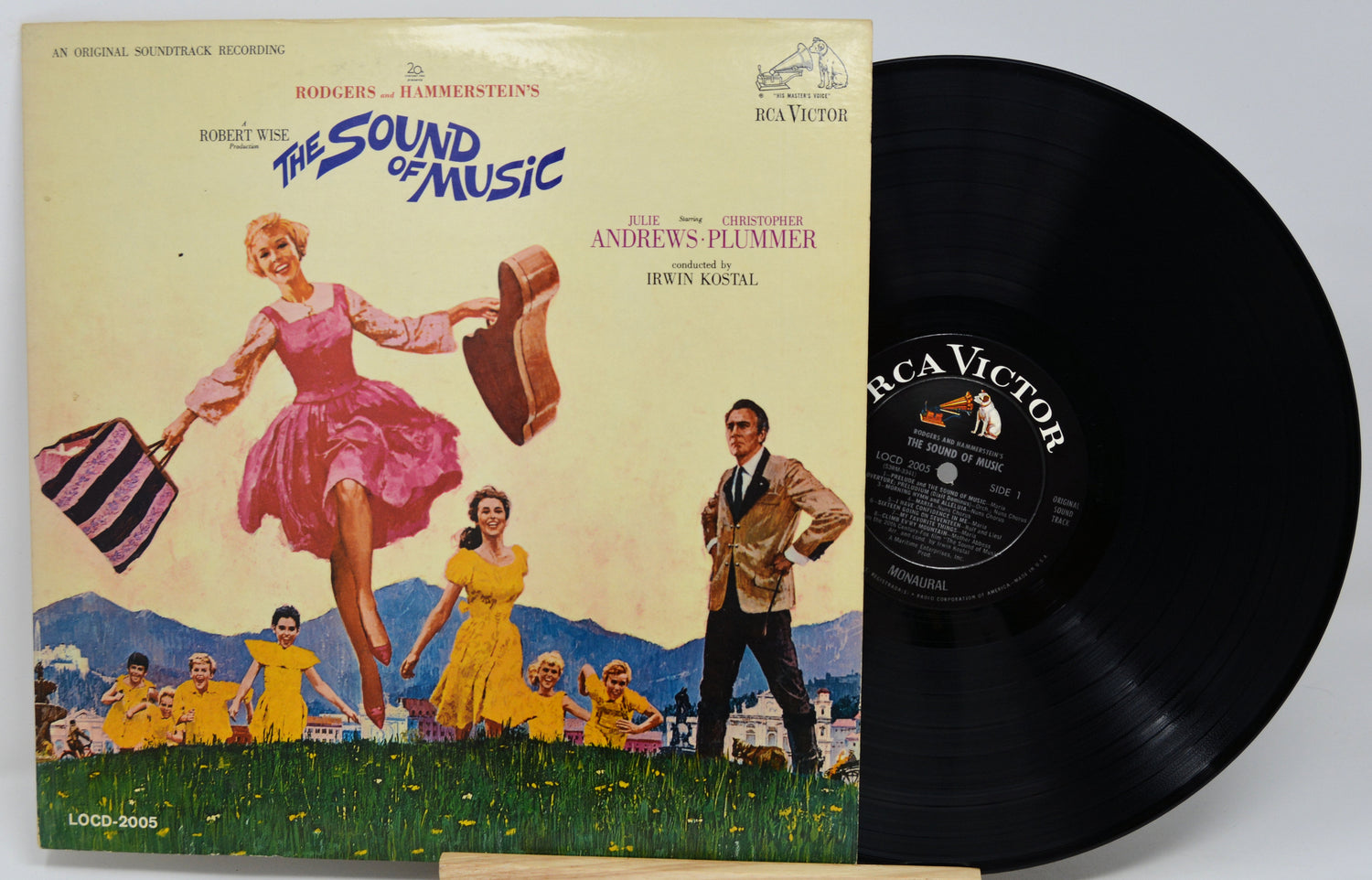 Vinyl record with cover featuring 'The Sound of Music' musical, showing a woman in a pink dress and a man with children.