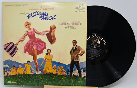 Vinyl record with cover featuring 'The Sound of Music' musical, showing a woman in a pink dress and a man with children.