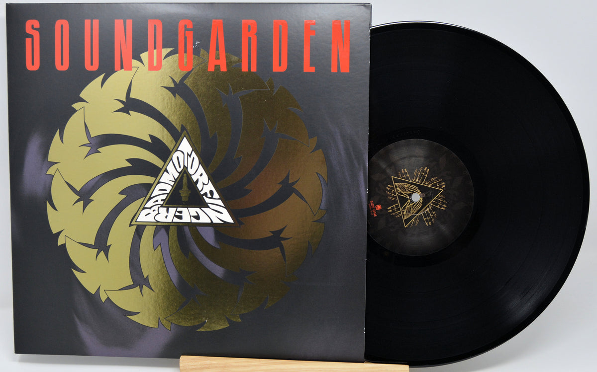 Soundgarden 'Superunknown' vinyl record LP with the album cover standing next to the black vinyl disc on a light gray background.