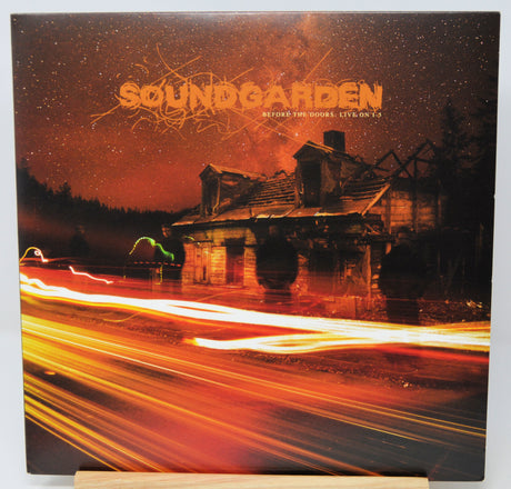 Soundgarden 'After the Fire: Live on 75' vinyl record cover, displayed on a wooden stand against a white background.