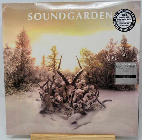 Soundgarden 'King Animal' vinyl record album cover, sealed in plastic with a free download sticker and a paper label, displayed on a wooden stand.