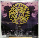 A vinyl record sleeve for 'Asylum' by the band Death Cab for Cutler, featuring a large gold spiral logo over a purple and black stormy sky background. The record is still sealed in its plastic shrink wrap and is photographed flat.