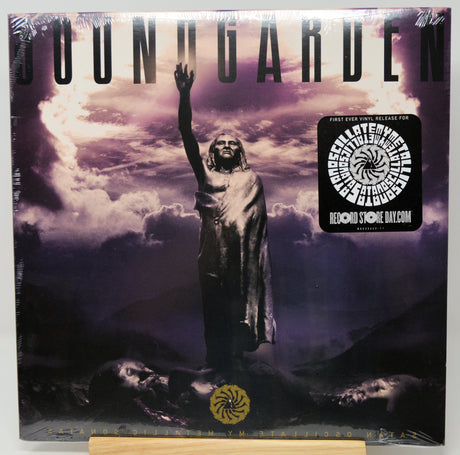 Soundgarden 'Fallen' CD album cover, sealed in plastic shrink wrap with a collectible sticker on the right, displayed on a wooden stand against a white background.