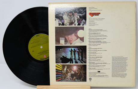 Vinyl record with cover featuring photos and text on a white background