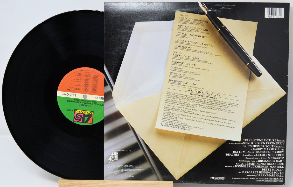 Vinyl record with a menu and pen on its cover