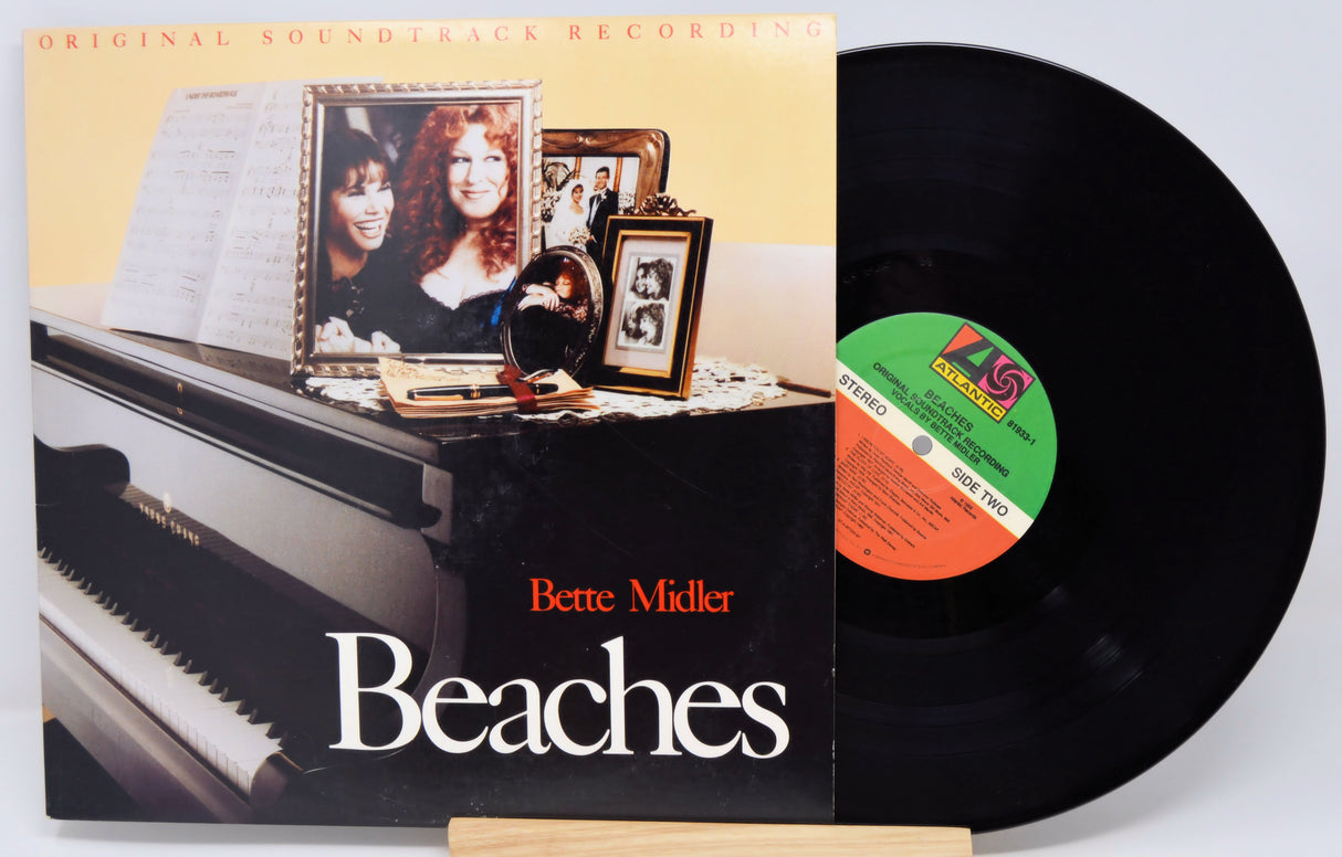 Vinyl record with cover featuring a piano and photos, titled 'Beaches' by Bette Midler.