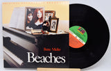 Vinyl record with cover featuring a piano and photos, titled 'Beaches' by Bette Midler.