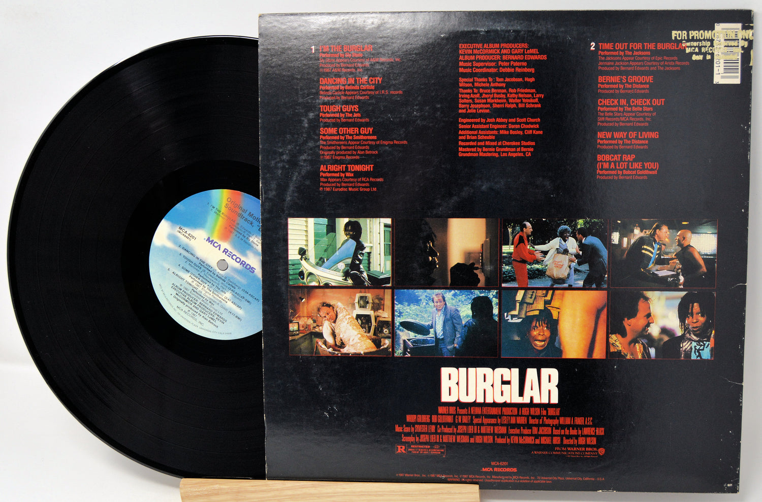 Vinyl record with its cover displaying album art and text.