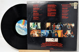 Vinyl record with its cover displaying album art and text.