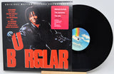 Vinyl record with cover featuring a person playing guitar, on a white background