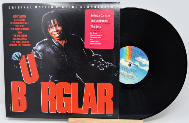 Vinyl record with cover featuring a person playing guitar, on a white background