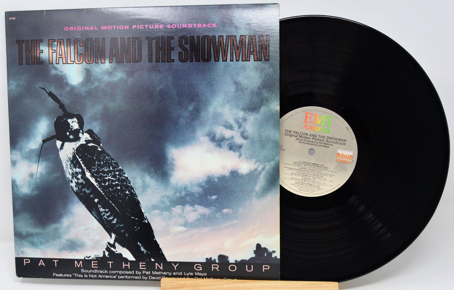 Vinyl record with 'The Falcon and the Snowman' soundtrack cover featuring a falcon and cloud design.