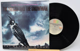 Vinyl record with 'The Falcon and the Snowman' soundtrack cover featuring a falcon and cloud design.