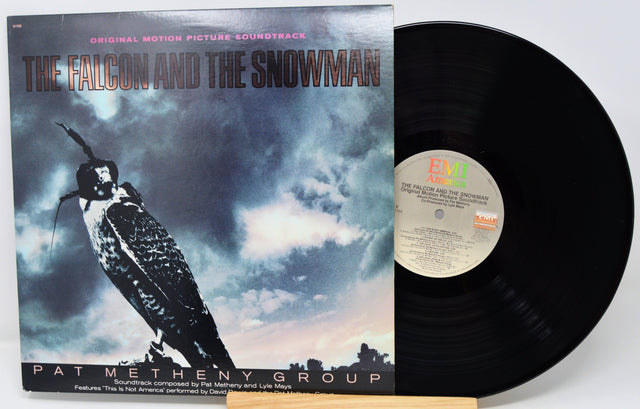 Vinyl record with 'The Falcon and the Snowman' soundtrack cover featuring a falcon and cloud design.
