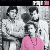 Album cover for 'Pretty in Pink' featuring three people in front of a brick wall.