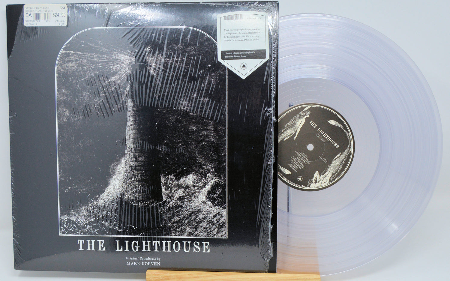 Vinyl record with 'The Lighthouse' cover and clear vinyl disc.