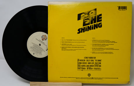 Vinyl record with yellow cover featuring 'The Shining' design