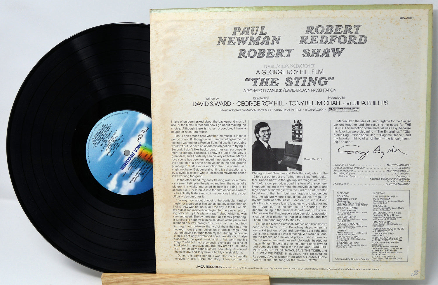 Vinyl record with cover featuring text and a black and white photo of a man.