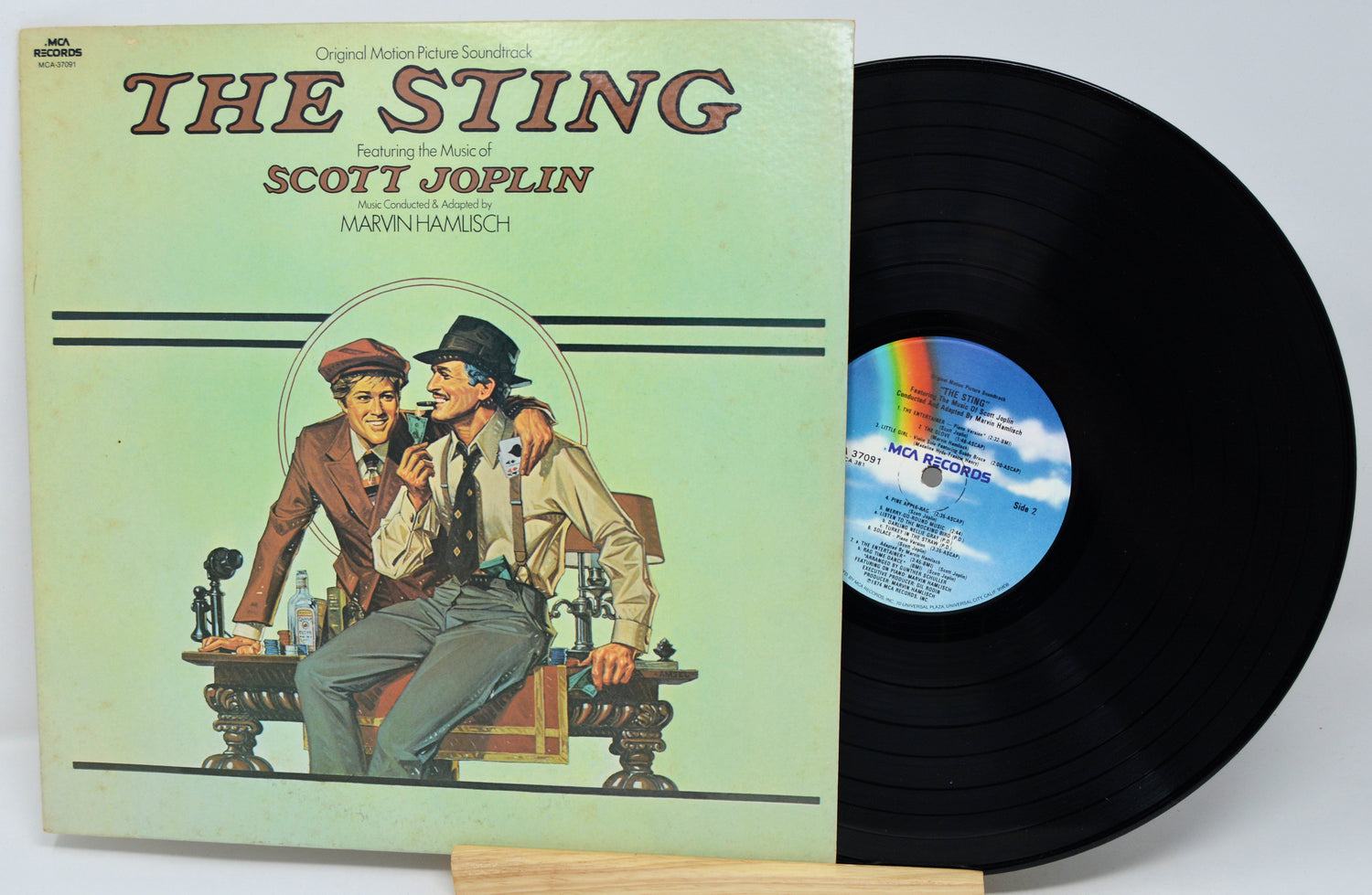 Vinyl record with cover featuring 'The Sting' and Scott Joplin, on a light gray background