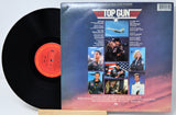 Vinyl record with 'Top Gun' album cover featuring military-themed artwork.