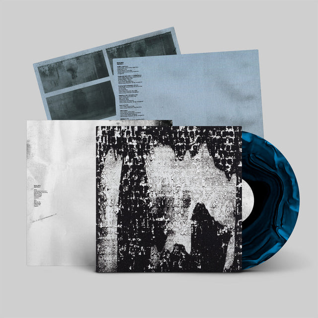 Vinyl record with a textured cover and blue sleeve on a gray background