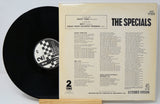 Vinyl record and its cover with 'The Specials' album details on a light gray background