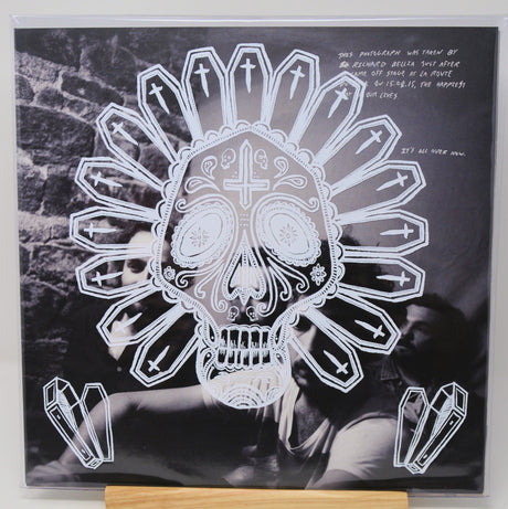 Vinyl record cover with a skull and crossbones design on a black background