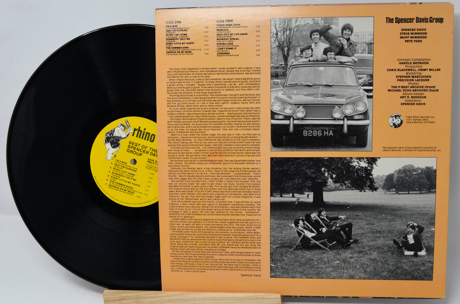 Vinyl record with a yellow label and its cover showing text and black and white photos.