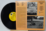 Vinyl record with a yellow label and its cover showing text and black and white photos.