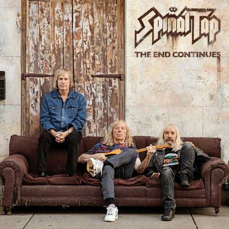 Spinal Tap band members on a vintage couch under 'The End Continues' album title