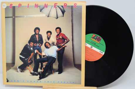 Vinyl record with cover featuring a group of people and album details.