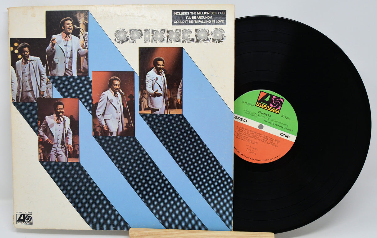Vinyl record with cover featuring images of a group and ZL Records label.