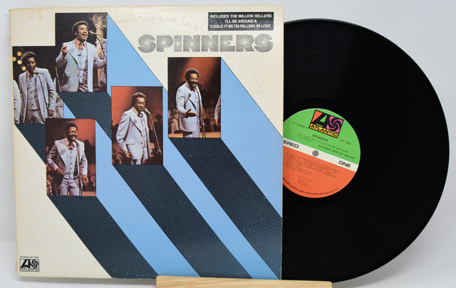 Vinyl record with cover featuring images of a group and ZL Records label.
