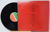 Vinyl record with red label and black disc on a white background