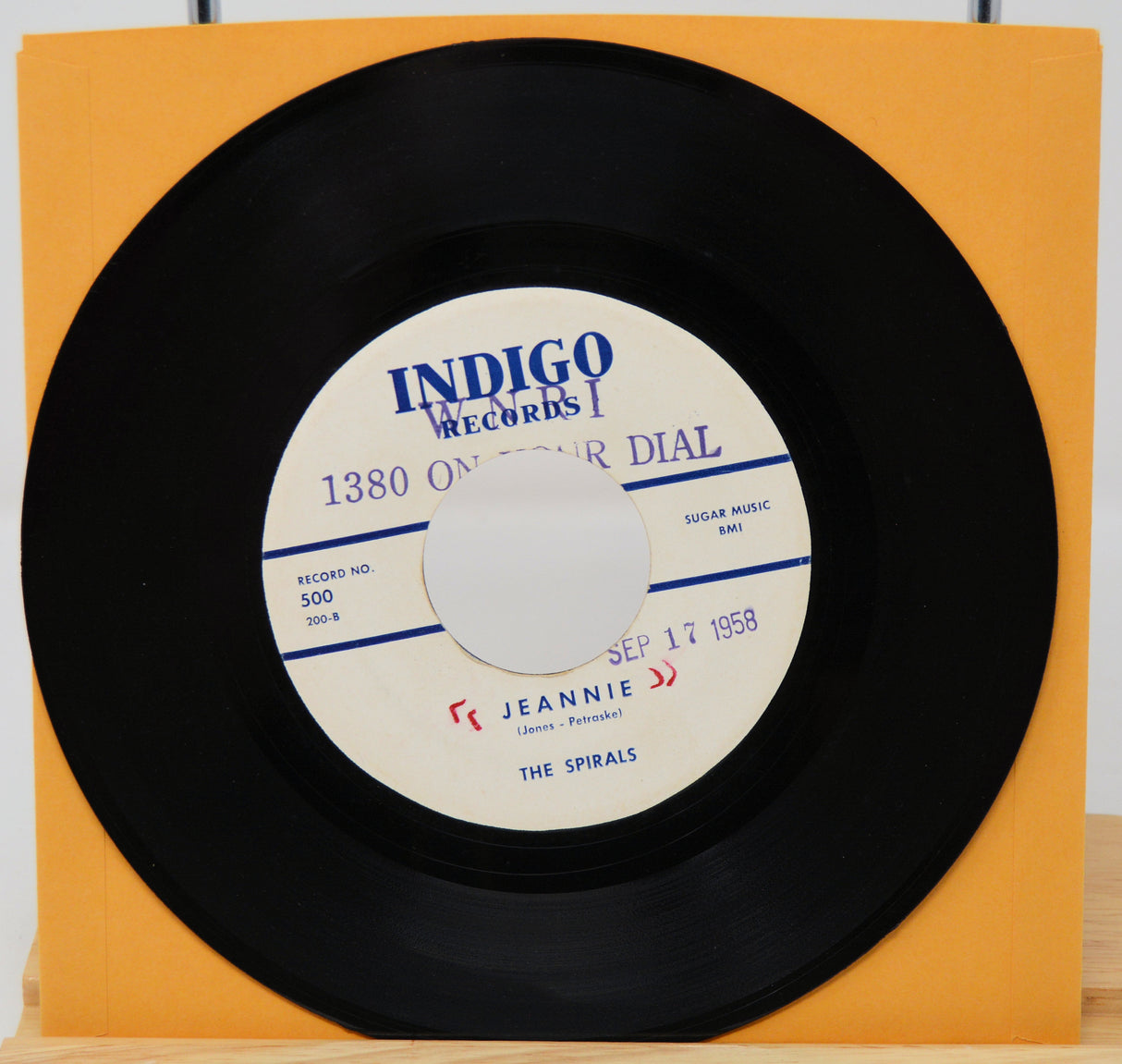 Vinyl record with a yellow sleeve on a white background